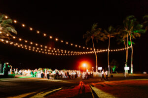 Professional videography, photography, and drone footage of a night outdoor event with string lights and palm trees.
