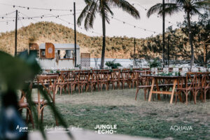 Jungle Echo – Low Res Export-2 Professional videography, photography, and drone footage outdoor event setup with wooden chairs and tropical backdrop
