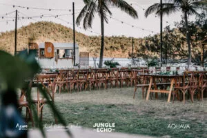 Professional videography, photography, and drone footage outdoor event setup with wooden chairs and tropical backdrop