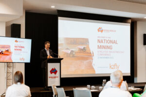 Professional videography, photography, and drone footage at a conference presentation displaying mining industry insights