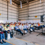 Corporate event photography – audience seated in industrial venue