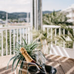 Balcony lifestyle photography – champagne bottle with ocean view