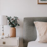 Interior bedroom photography – neutral palette with bedside lamp