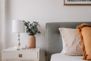 Interior bedroom photography – neutral palette with bedside lamp