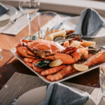 Aerial yacht photography – boat on deep green water