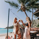 Lifestyle photography – champagne glasses clinking on yacht