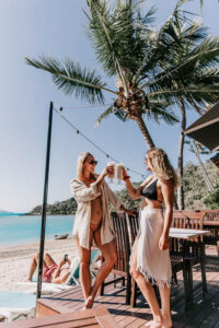 Lifestyle photography – champagne glasses clinking on yacht