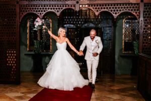 Professional videography capturing joyful wedding couple entrance