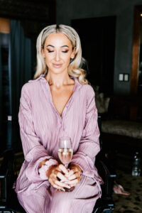 Professional videography woman enjoying sparkling wine