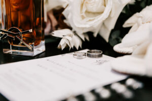 Professional videography and wedding rings with romantic flowers