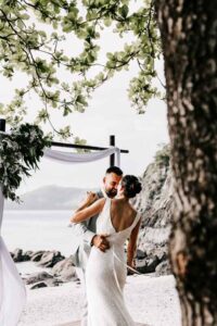Professional videography, photography, and drone footage wedding couple by the beach.