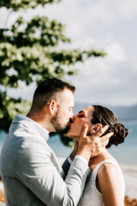 Professional videography beach wedding couple sharing a kiss