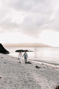 Professional videography photography drone shot of beach couple