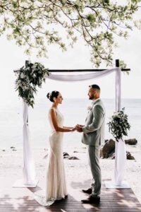 Professional videography capturing a beach wedding ceremony scene