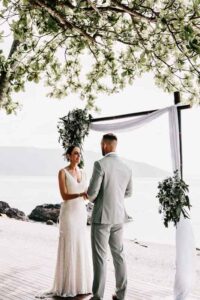 Professional videography at a scenic outdoor beach wedding ceremony