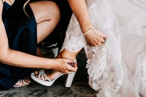 Professional videography and photography of bride's shoe fitting
