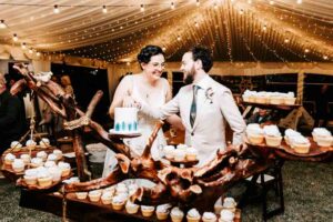 Professional videography, photography, and drone footage at wedding reception with cupcakes and fairy lights