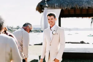 Professional videography at a sunny beach wedding ceremony