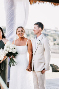Professional videography wedding couple holding hands outdoors
