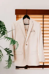 Professional videography featuring a beige suit on a hanger