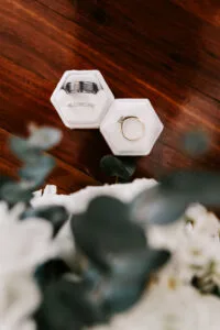 Professional videography wedding rings on wooden table surface