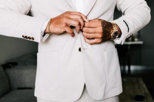 Professional videography photography and drone footage man buttoning suit