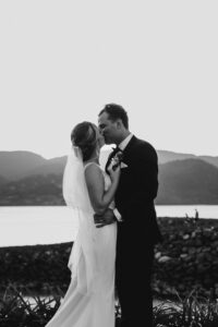 Professional videography showcasing wedding couple by serene lake