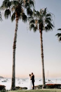Professional videography, photography, and drone footage of couple by sea.