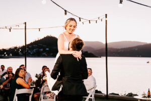 Professional videography wedding celebration by the water at sunset