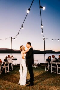 Professional videography wedding couple dancing by a lake