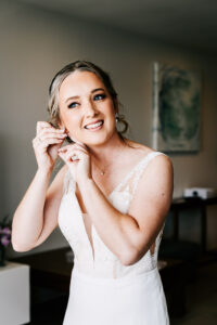 Professional videography wedding bride adjusting earring indoor