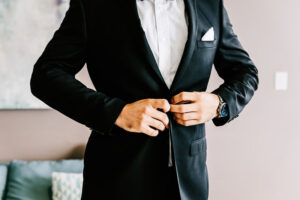 Professional videography man buttoning suit jacket promo shoot