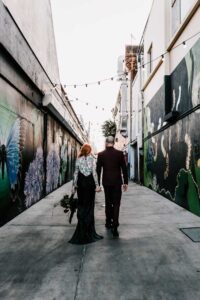 Professional videography in colorful urban alley with couple walking