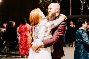 Professional videography, photography, and drone footage capture a joyful wedding dance moment.