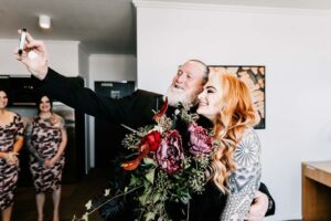 Professional videography capturing joyful wedding moments indoors