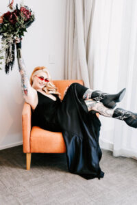 Professional videography woman in black dress holding flowers