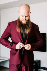 Professional videography, photography, man in a maroon suit