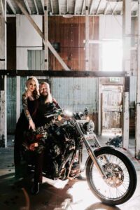Professional videography capturing couple on motorcycle indoors