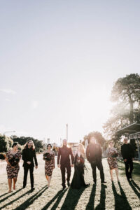 Professional videography captures elegant wedding party outdoors