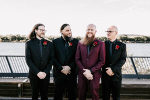 Professional videography group outdoors in formal attire smiling