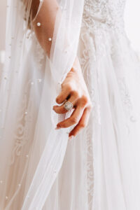Professional videography wedding bride holding dress close-up