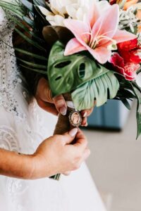 Professional videography focus on bride holding floral bouquet
