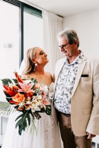 Professional videography captures bride with bouquet smiling warmly