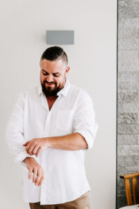 Professional videography, photography, man adjusting sleeves indoors