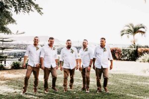 Professional videography capturing groomsmen in tropical setting