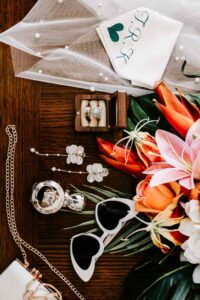 Professional videography wedding flat lay with jewelry and flowers