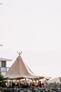 Professional videography capturing outdoor tent gathering setup