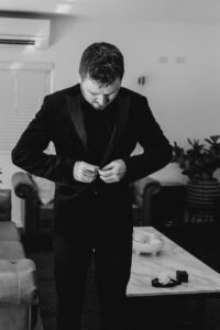 W+R 12-08-23 Th3rd Dimension Media WR-31 Professional videography man in suit adjusts tuxedo indoors