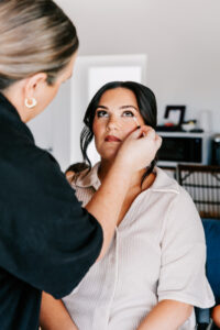Professional videography, photography makeup artist preps client