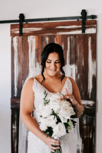 Professional videography elegant bride holding white bouquet indoors